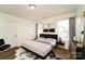 Main bedroom with plush carpeting and a large window at 2327 Hope Valley Ln, Charlotte, NC 28213