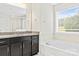 Bathroom showcasing a soaking tub, granite vanity, and large mirror at 3023 Spinner Ct, Denver, NC 28037