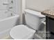 Bathroom showcases a toilet, bathtub, and tiled walls, providing a functional space at 3023 Spinner Ct, Denver, NC 28037