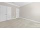 Spacious bedroom with neutral carpet, base molding, and multiple closets at 3023 Spinner Ct, Denver, NC 28037