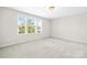 Bedroom features carpet flooring, a large window providing natural light at 3023 Spinner Ct, Denver, NC 28037