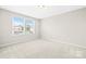 Well-lit bedroom with carpet flooring, windows for natural light, and neutral wall color at 3023 Spinner Ct, Denver, NC 28037