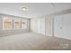 Bonus room with neutral carpet, large window, and white trim and doors at 3023 Spinner Ct, Denver, NC 28037