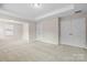 Bonus room features neutral carpet, tray ceiling, and white trim and doors at 3023 Spinner Ct, Denver, NC 28037