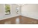 Dining room with ample natural light, hardwood floors, and elegant chandelier at 3023 Spinner Ct, Denver, NC 28037