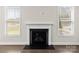 Cozy fireplace with white mantle, hardwood floors and large windows offering plenty of natural light at 3023 Spinner Ct, Denver, NC 28037