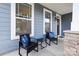 Inviting front porch with seating area and stone column details at 3023 Spinner Ct, Denver, NC 28037