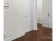 View of a hallway with dark wood floors and white trim and white doors at 3023 Spinner Ct, Denver, NC 28037
