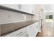 Modern kitchen features white cabinets, granite countertops, subway tile backsplash and stainless steel appliances at 3023 Spinner Ct, Denver, NC 28037