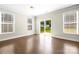 Bright living space featuring hardwood floors, large windows, and sliding glass doors to the backyard at 3023 Spinner Ct, Denver, NC 28037