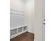 Mudroom entryway with built-in bench, storage cubbies, and hardwood flooring at 3023 Spinner Ct, Denver, NC 28037