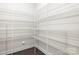 Walk-in pantry featuring white wire shelving and dark hardwood flooring for optimal storage at 3023 Spinner Ct, Denver, NC 28037