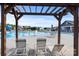 Relaxing poolside view through a pergola, showcasing lounge chairs and community amenities at 3023 Spinner Ct, Denver, NC 28037