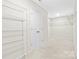 Spacious walk-in closet with white wire shelving and neutral carpeting provides ample storage at 3023 Spinner Ct, Denver, NC 28037