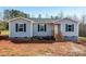 Newly constructed single-story home with gray siding and blue shutters at 7741 Marlette Ln, Sherrills Ford, NC 28673