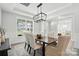 Elegant dining room with wainscoting, designer lighting, and large window at 2016 Cedar Falls Dr # 7, Waxhaw, NC 28173