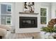 Close-up of a modern fireplace with a shiplap surround, wood mantel, and natural light at 2016 Cedar Falls Dr # 7, Waxhaw, NC 28173