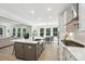 Modern kitchen with an island, stainless steel appliances, white countertops, and a view into the living room at 2016 Cedar Falls Dr # 7, Waxhaw, NC 28173