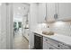Gourmet kitchen with wine fridge, white cabinetry, and stone backsplash at 2016 Cedar Falls Dr # 7, Waxhaw, NC 28173