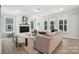Bright living room features a cozy fireplace, large windows, and stylish furnishings at 2016 Cedar Falls Dr # 7, Waxhaw, NC 28173
