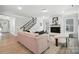 Inviting living room with a fireplace, staircase, hardwood floors, and comfortable seating at 2016 Cedar Falls Dr # 7, Waxhaw, NC 28173