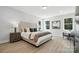 Bright main bedroom with stylish accents, comfortable seating area, and large windows at 2016 Cedar Falls Dr # 7, Waxhaw, NC 28173
