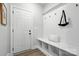 Bright mudroom features beadboard accent wall, coat hooks, built-in bench, and durable flooring at 2016 Cedar Falls Dr # 7, Waxhaw, NC 28173