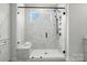 Modern walk-in shower with marble-like tiles, bench, and a sleek glass enclosure at 2016 Cedar Falls Dr # 7, Waxhaw, NC 28173