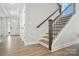Open staircase with modern railing design complements the light-filled entry area at 2016 Cedar Falls Dr # 7, Waxhaw, NC 28173