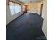 Large living area with dark carpet and lots of natural light at 1027 Morningside Park Dr, Gastonia, NC 28054