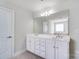 A spacious bathroom features a double vanity with a large mirror and white cabinets at 14447 Waterlyn Dr, Charlotte, NC 28278