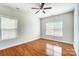 Bedroom with hardwood floors, neutral walls, and lots of natural light at 14447 Waterlyn Dr, Charlotte, NC 28278