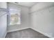 Bright bedroom featuring a window with views and a closet with shelving at 14447 Waterlyn Dr, Charlotte, NC 28278