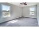 Bright bedroom featuring two large windows and a ceiling fan with lighting at 14447 Waterlyn Dr, Charlotte, NC 28278