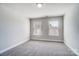 A bright bedroom offers neutral walls and carpet plus two large windows at 14447 Waterlyn Dr, Charlotte, NC 28278