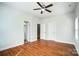 An empty bedroom that features hard wood floors, a ceiling fan and two windows at 14447 Waterlyn Dr, Charlotte, NC 28278