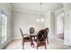 This dining room showcases a glass table, seating for four, and natural light from windows at 14447 Waterlyn Dr, Charlotte, NC 28278