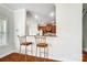View of the kitchen bar and a glimpse of the kitchen with stainless steel appliances at 14447 Waterlyn Dr, Charlotte, NC 28278