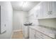 Well-lit laundry room with ample cabinet space, granite countertops, and a washer/dryer at 14447 Waterlyn Dr, Charlotte, NC 28278