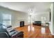 Spacious living room featuring hardwood floors, a fireplace, and ample natural light at 14447 Waterlyn Dr, Charlotte, NC 28278