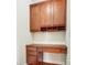 A desk with upper cabinets in an office area featuring wood floors and neutral wall paint at 14447 Waterlyn Dr, Charlotte, NC 28278