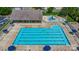 Aerial view of large community pool, blue umbrellas, and lounge chairs at 14447 Waterlyn Dr, Charlotte, NC 28278
