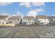 Backyard view showcasing the back of multiple grey two story homes at 130 Summerhill Dr # 16, Mooresville, NC 28115