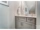 Stylish powder room features gray vanity with modern fixtures and white countertop at 130 Summerhill Dr # 16, Mooresville, NC 28115