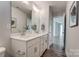 Bright bathroom featuring double sinks, white cabinets, modern fixtures and wood look flooring at 130 Summerhill Dr # 16, Mooresville, NC 28115