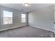Cozy bedroom with plush carpet and natural light streaming through two windows at 130 Summerhill Dr # 16, Mooresville, NC 28115