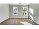 Inviting bedroom with natural light streaming through two windows and plush carpet at 130 Summerhill Dr # 16, Mooresville, NC 28115