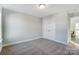 Spacious bedroom with natural light, soft carpet, and a walk in closet at 130 Summerhill Dr # 16, Mooresville, NC 28115