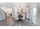 Dining area leading to the modern kitchen features table with white chairs and great natural light at 130 Summerhill Dr # 16, Mooresville, NC 28115