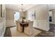 Elegant dining room with classic wainscoting, a stylish chandelier, and a spacious table for Gathering gatherings at 130 Summerhill Dr # 16, Mooresville, NC 28115